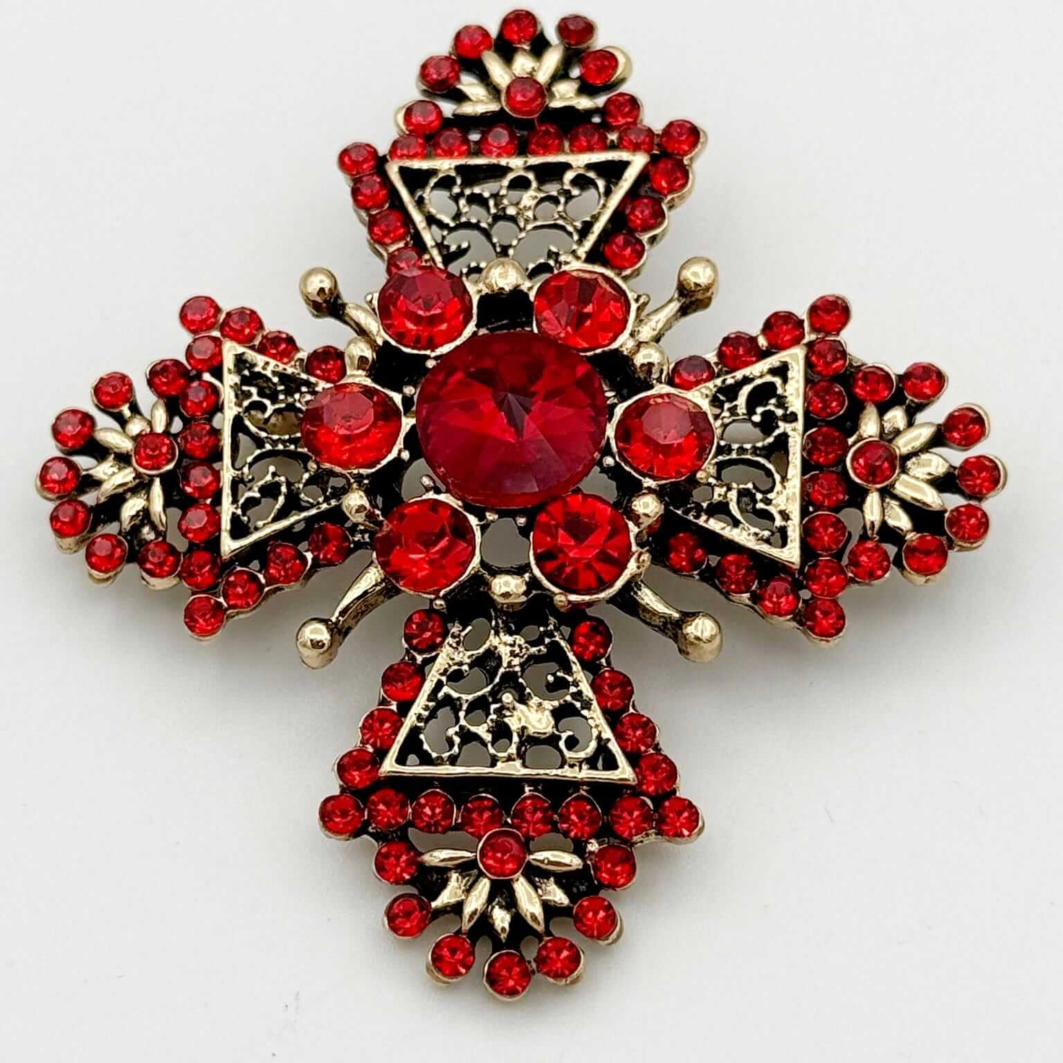 Intricate Gold Tone Red Crystal Cross Brooch